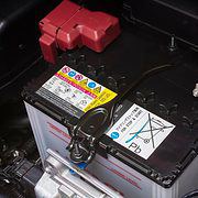 Car battery in it's location under the hood