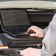 A laptop in a car's engine bay