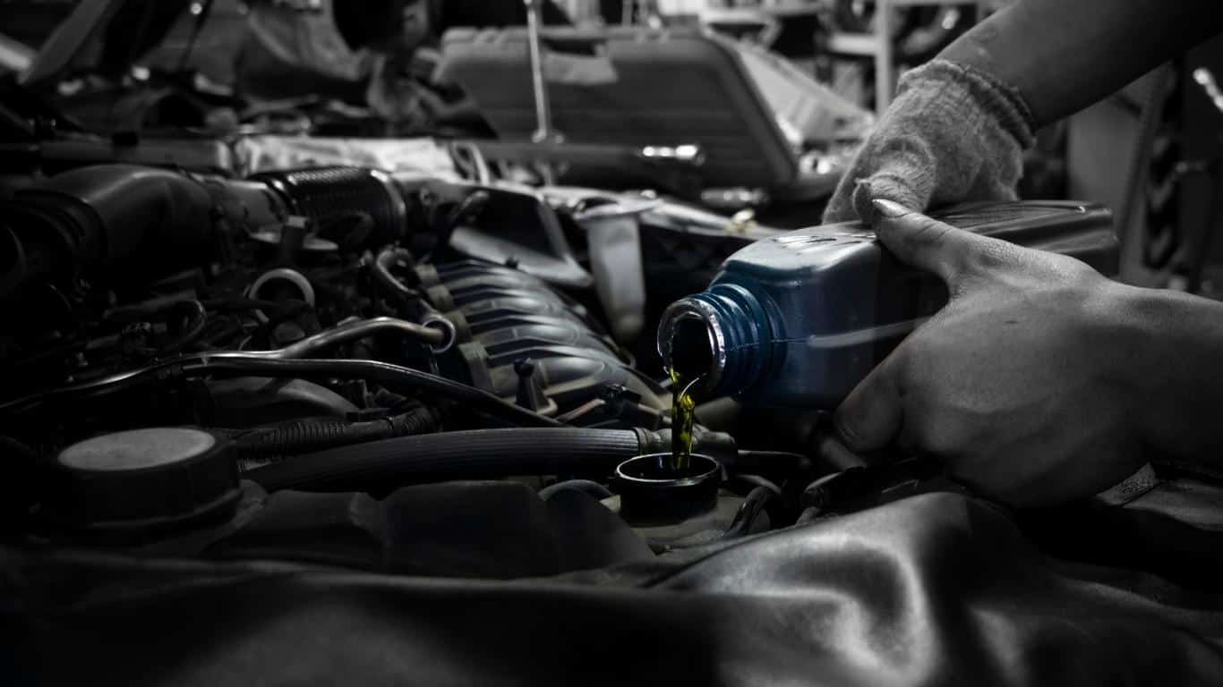 Engine oil being poured into a car engine