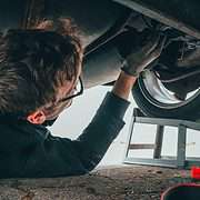 Man under a car changing the oil