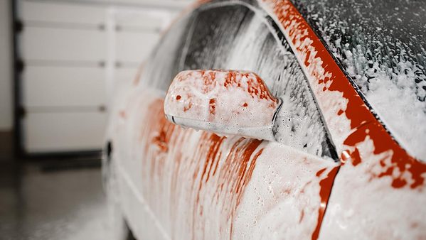 Red car covered in soap