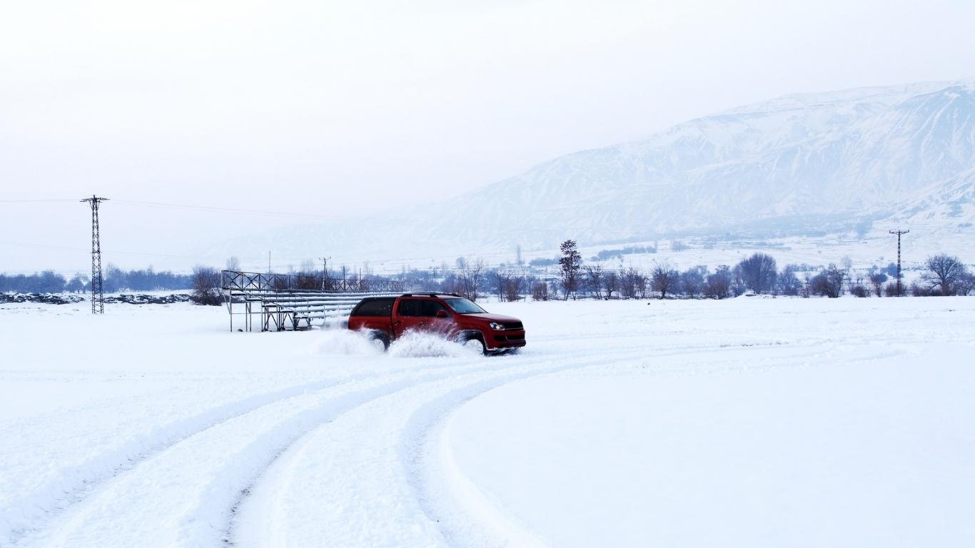 Red SUV skidding on snow