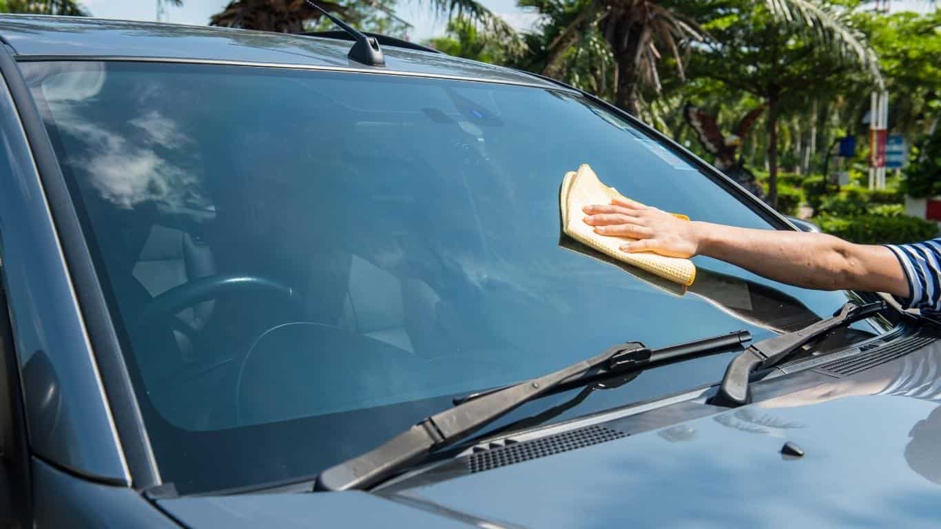 wiping the windshield of an SUV